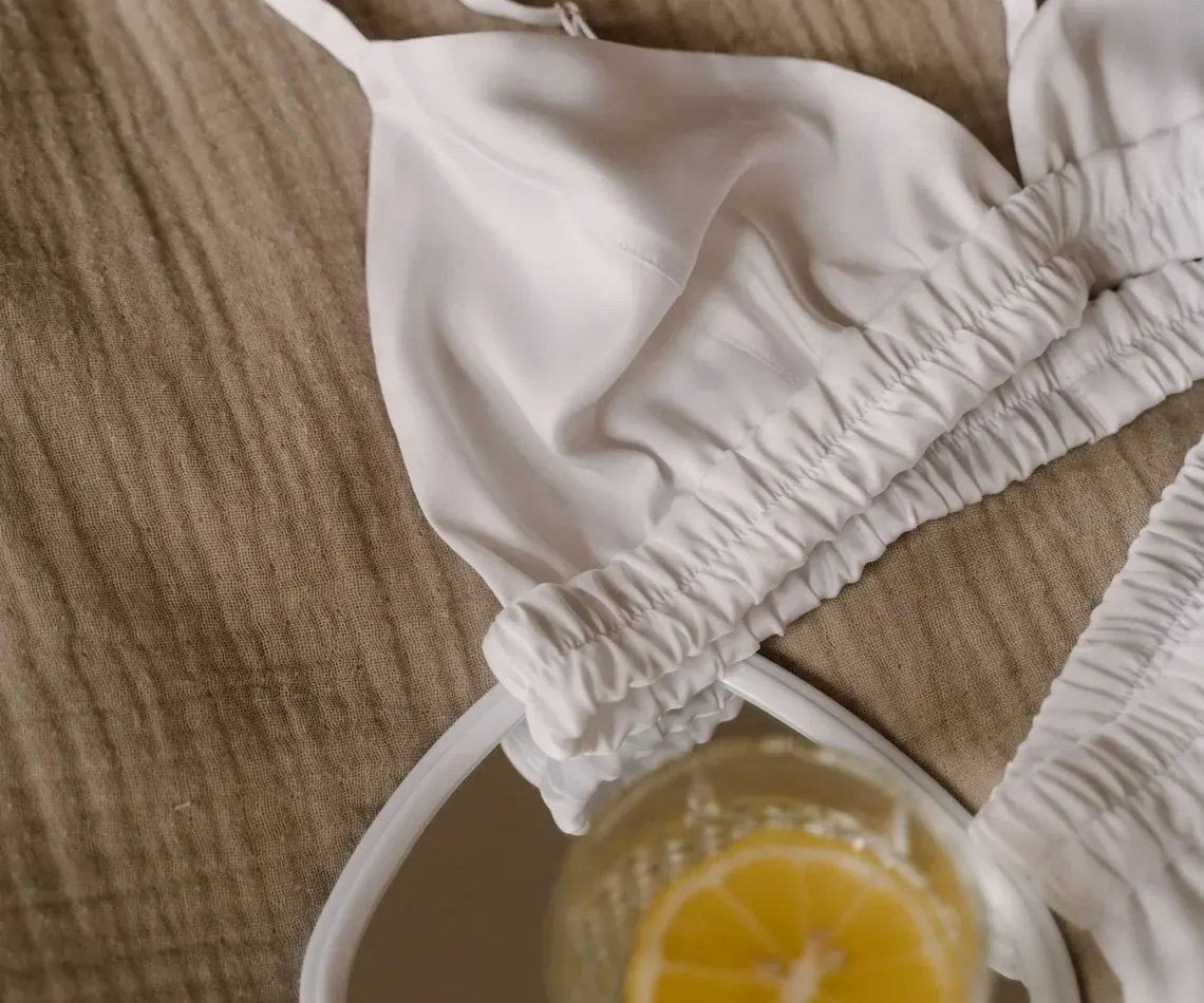 Neutral garment flat lay supporting the complete first-bra guide