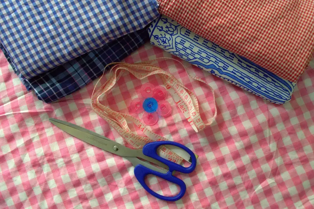Fabric, measuring tape and sewing tools illustrating measurement and construction