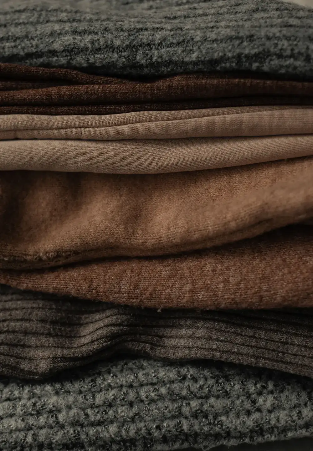 Stacked folded knit fabrics showing different textures used in bra construction