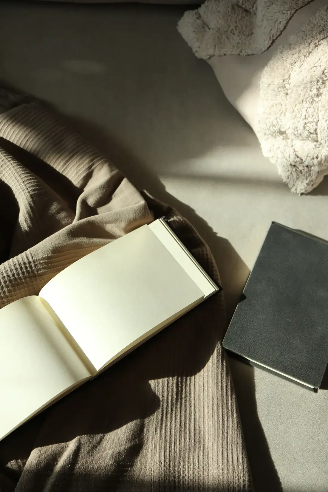 Notebook and soft neutral fabric representing a calm decision process