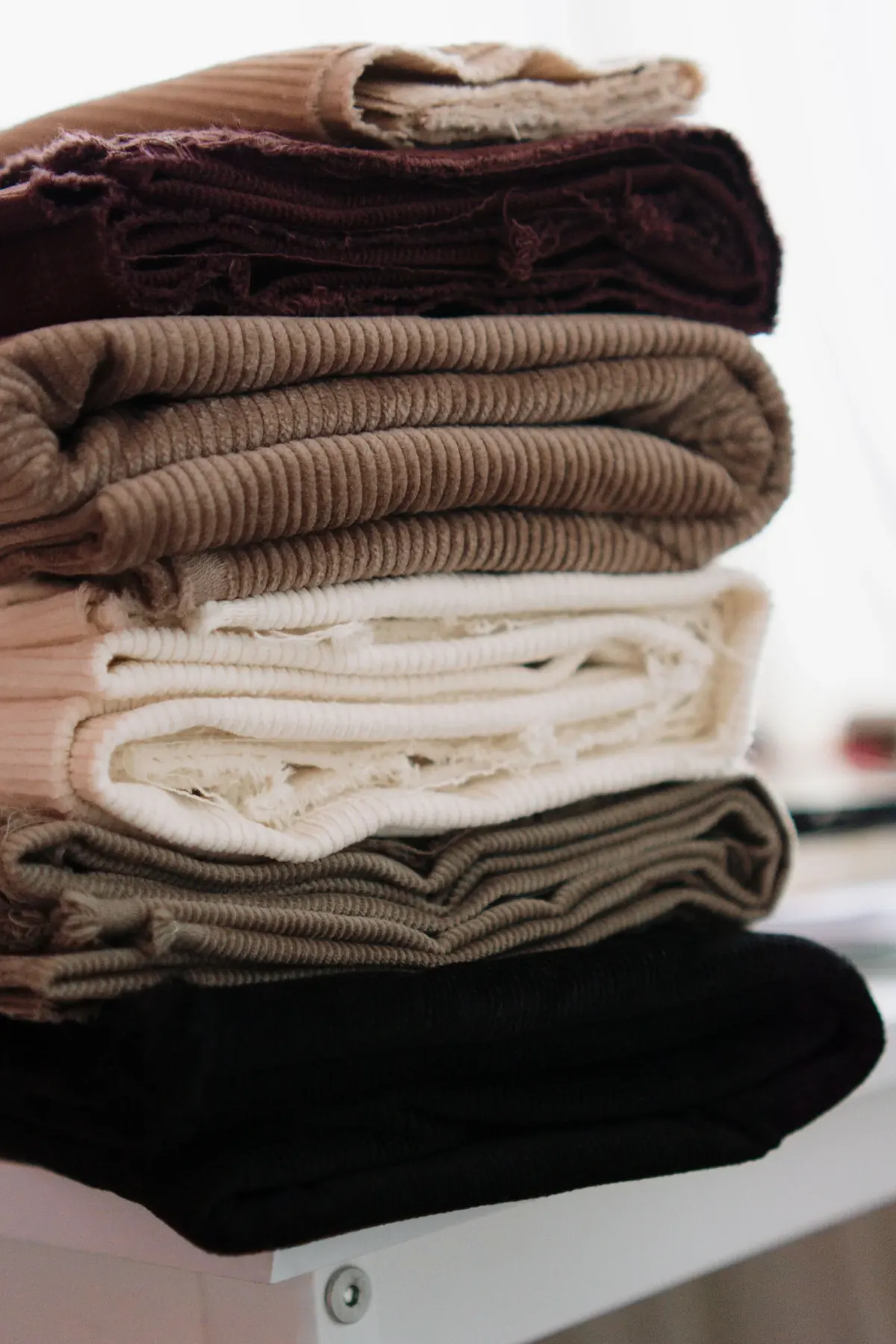Minimal beige bra displayed against a neutral textile background