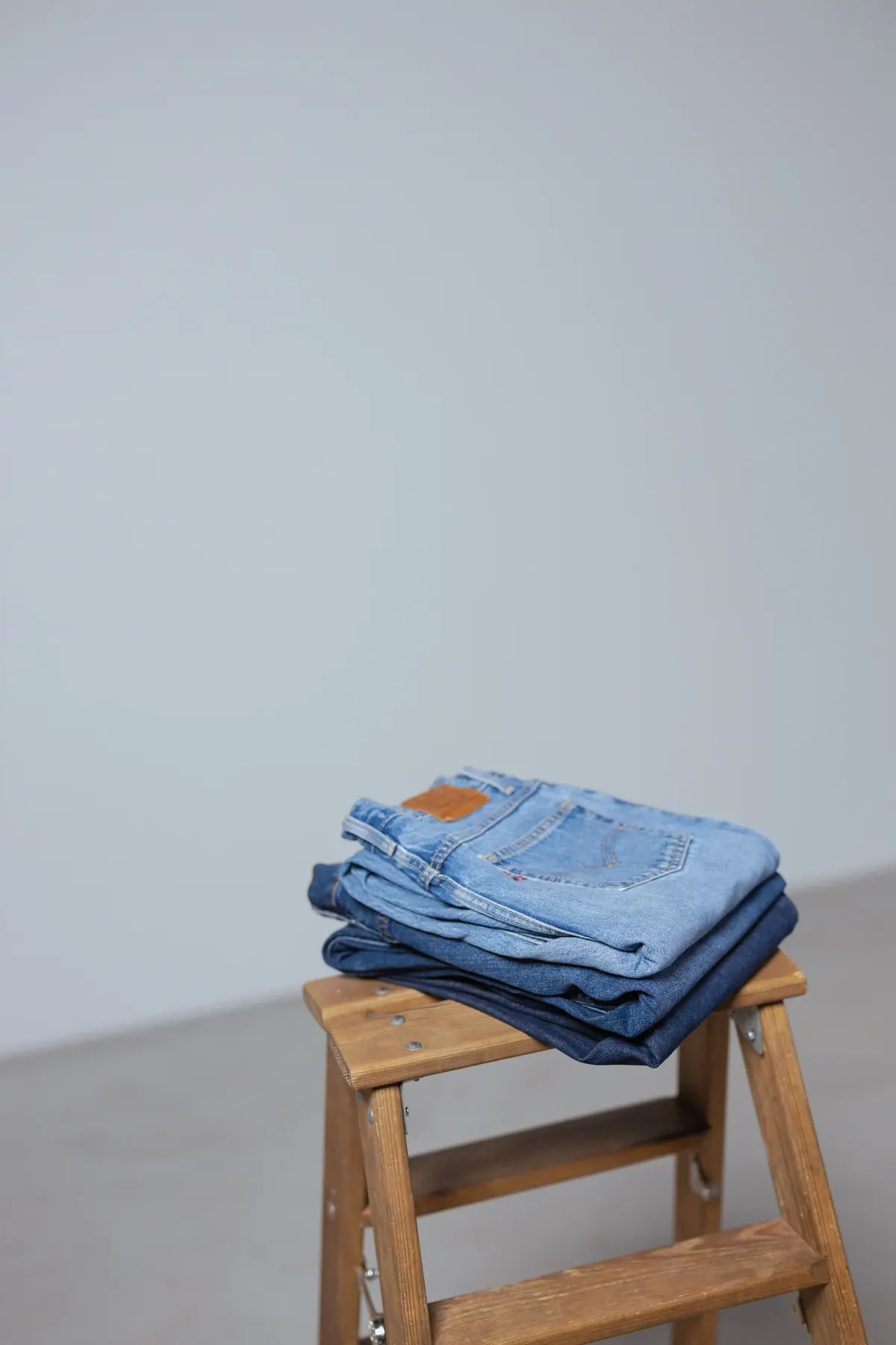 Minimal sleeveless garment arranged beside simple packaging