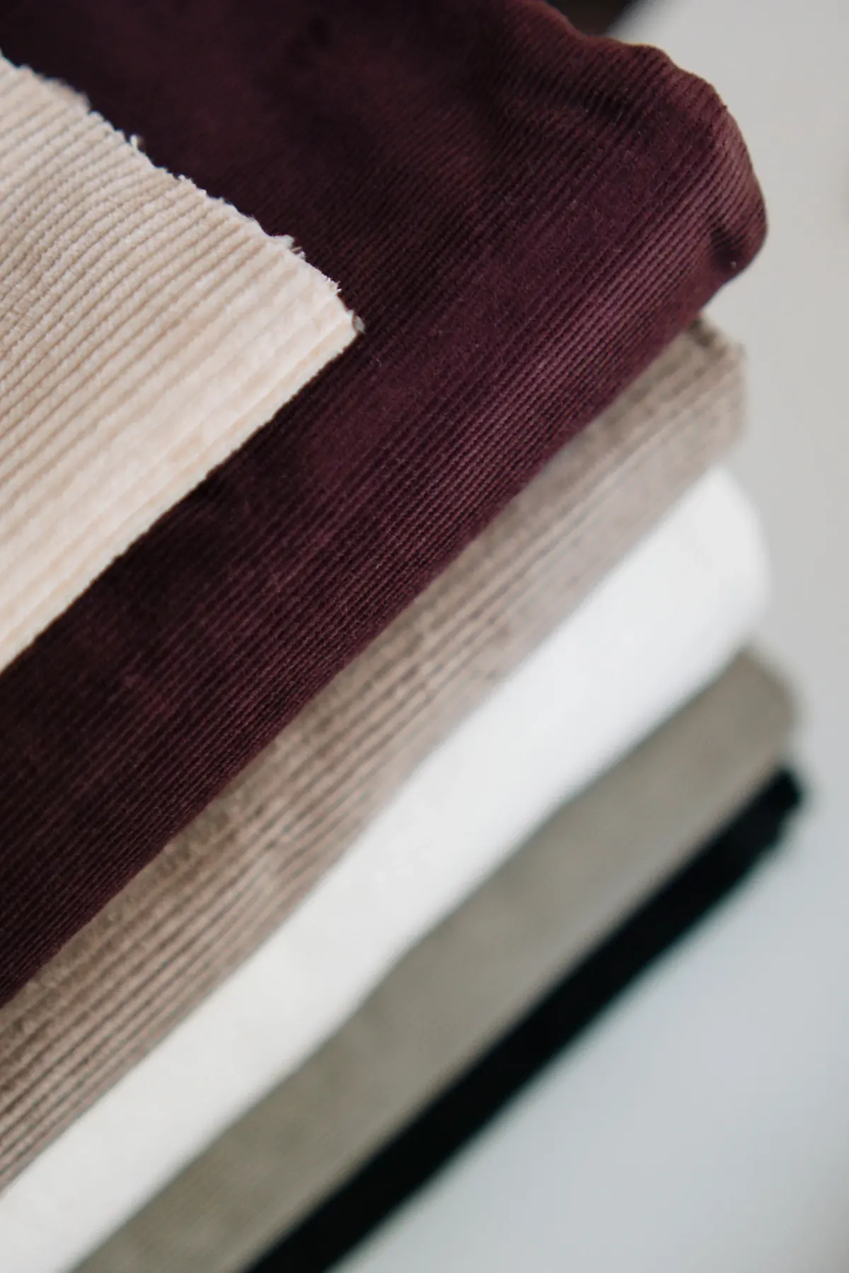 Layered neutral fabrics showing smooth and textured surfaces
