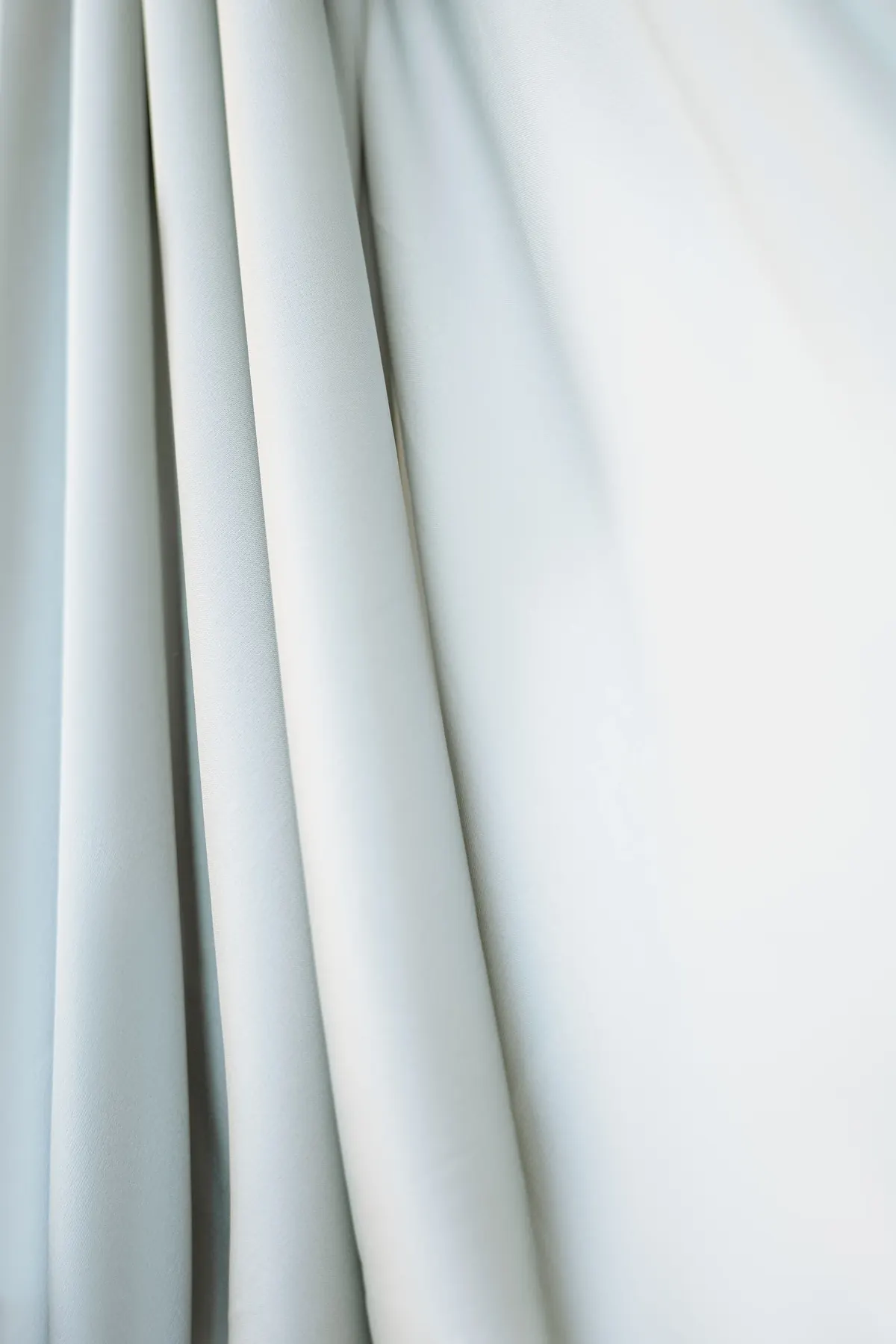 Smooth white textile folds illustrating low-visibility clothing layers